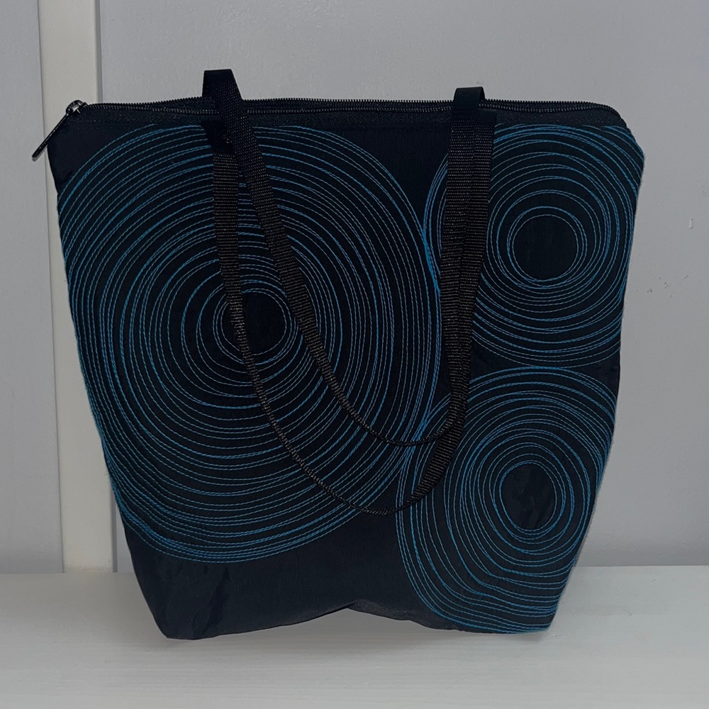 Black and Blue Embroidered Tenacious Tote Bag with signature blue spirals